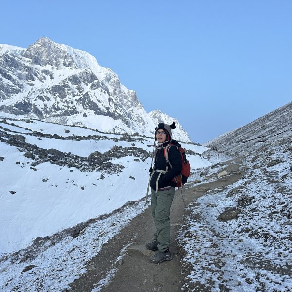 rekker walking along a snowy trail on the Manaslu Circuit Trek