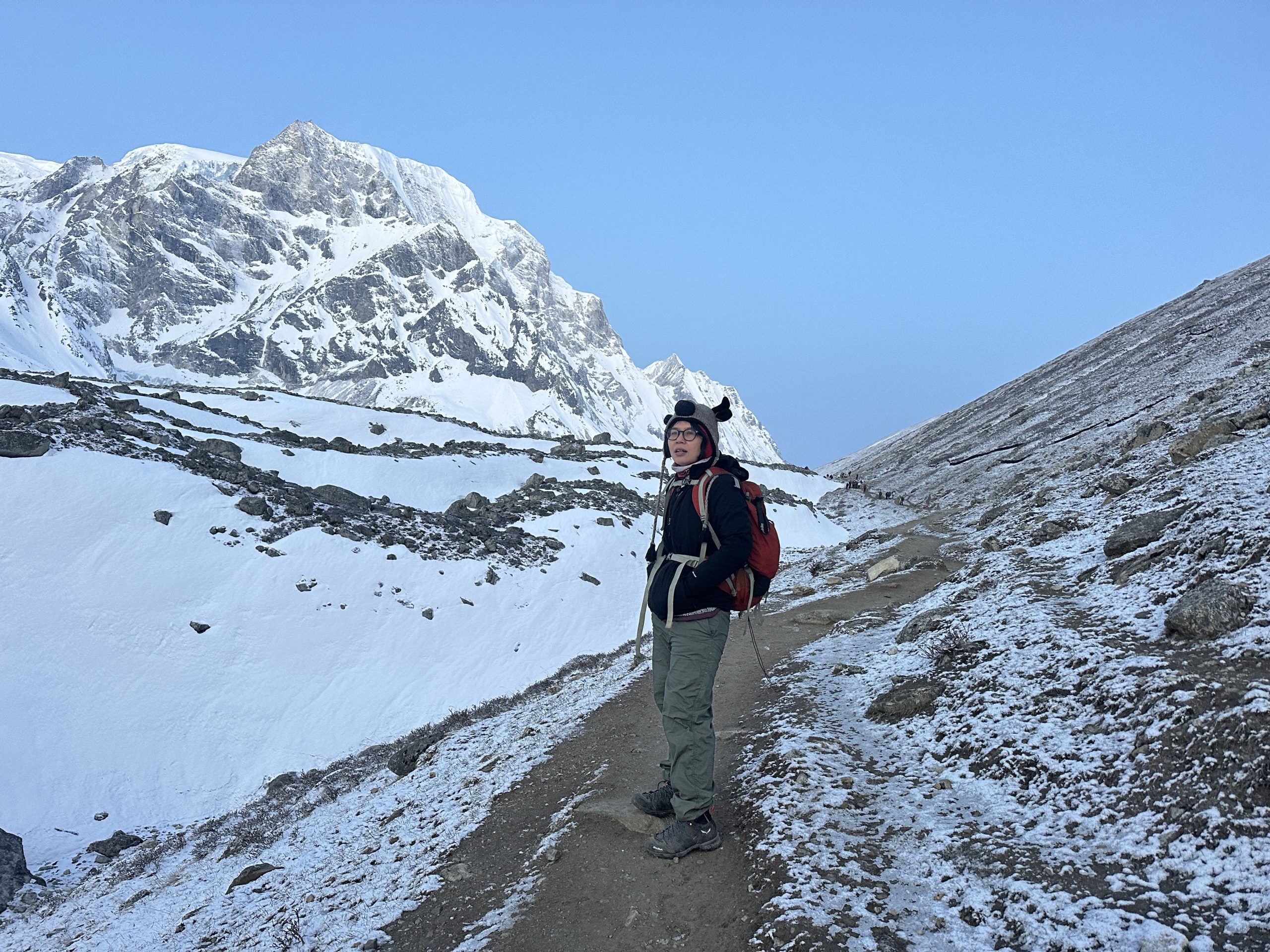 rekker walking along a snowy trail on the Manaslu Circuit Trek