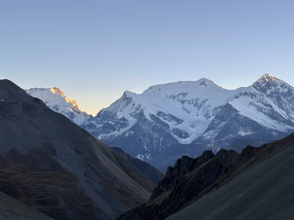 Snow-capped Himalayan peaks seen from the Annapurna Circuit trek in Nepal during early morning light
