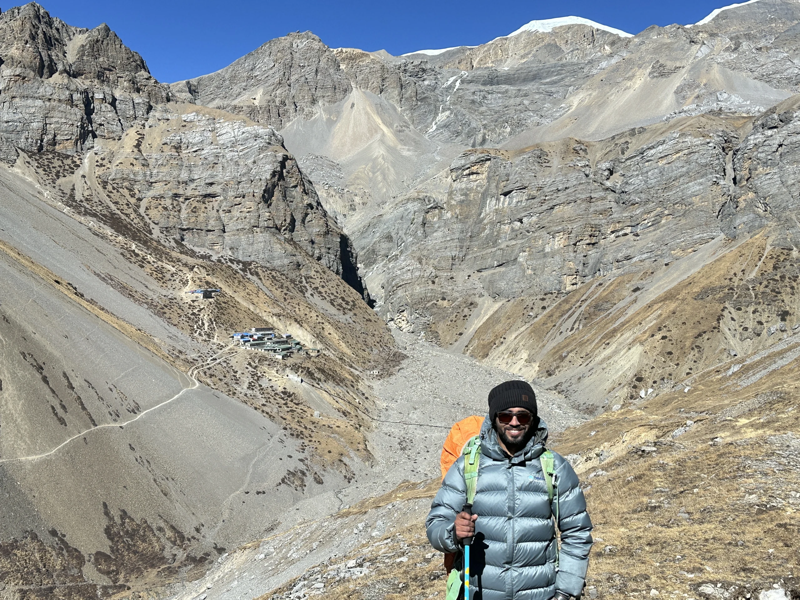 Trekker hiking on the Annapurna Circuit with dramatic rocky mountains and high-altitude landscape in Nepal