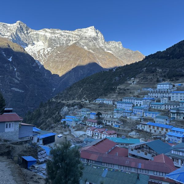 Panoramic view of Namche Bazaar with snow-capped Himalayan peaks in the Everest region of Nepal.