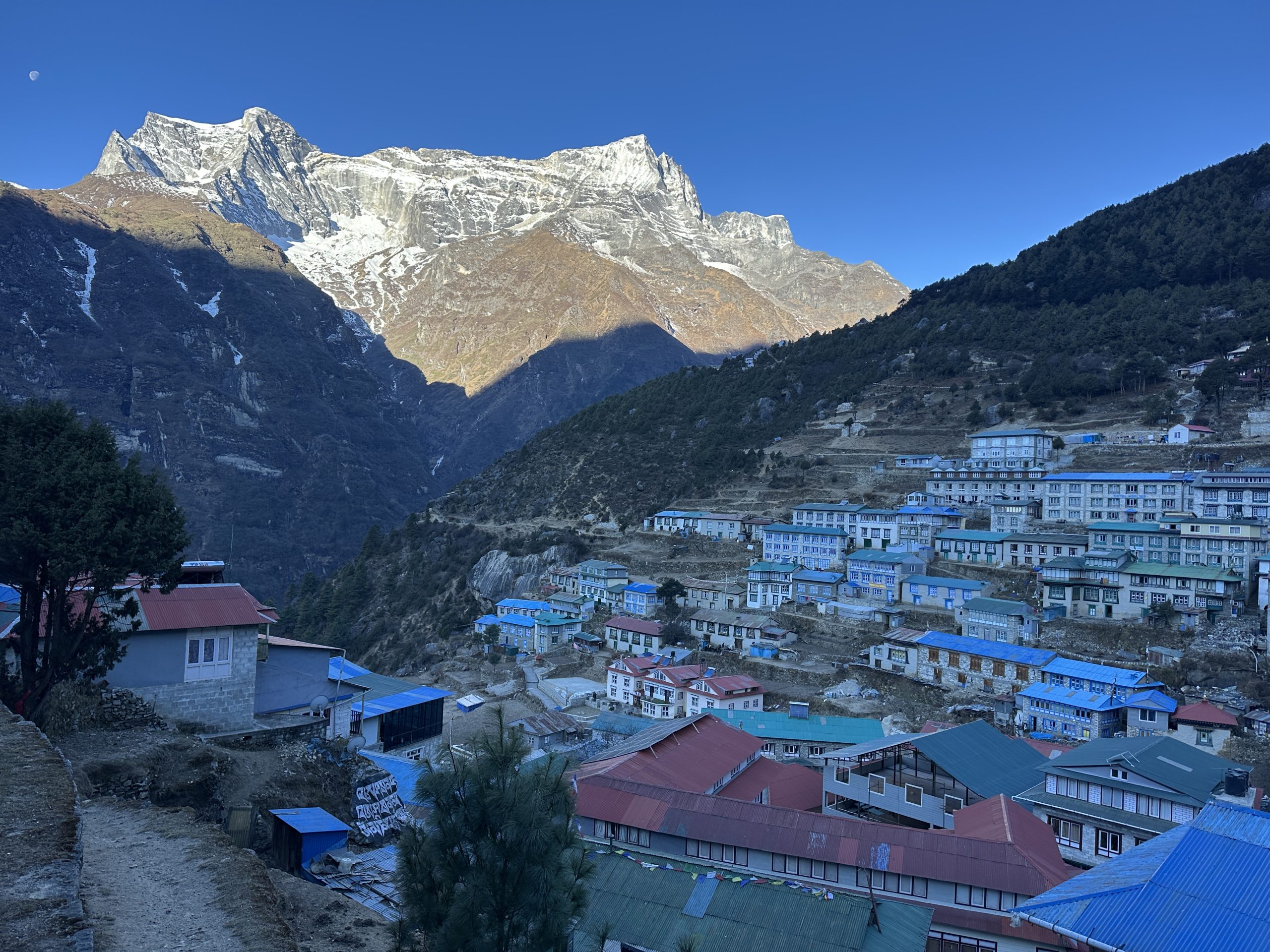 Panoramic view of Namche Bazaar with snow-capped Himalayan peaks in the Everest region of Nepal.