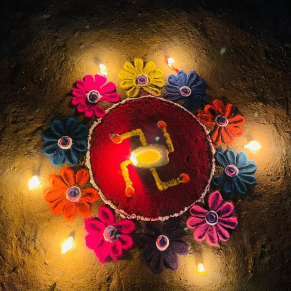olorful Tihar rangoli decorated with flowers and glowing diyas
