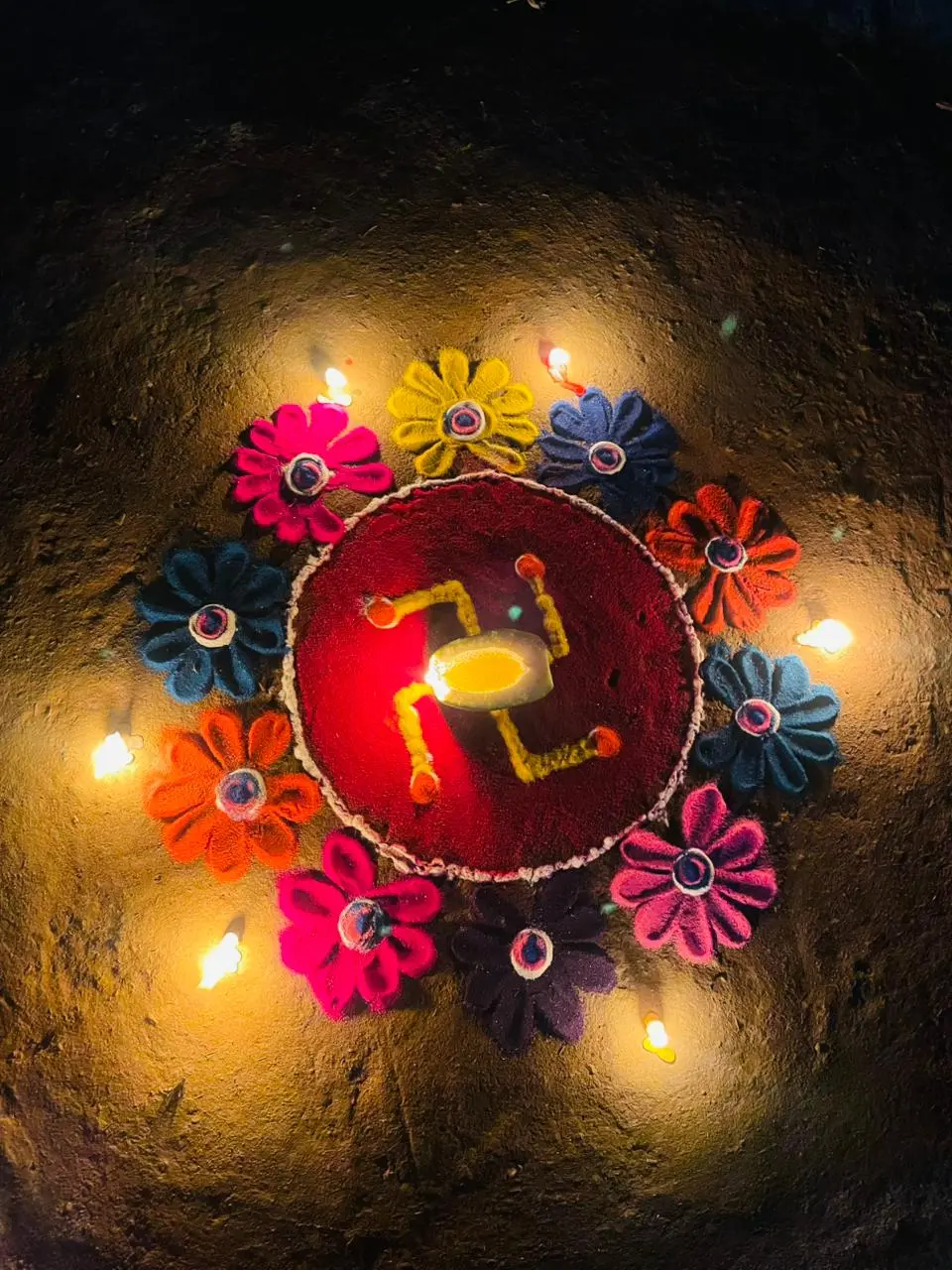 olorful Tihar rangoli decorated with flowers and glowing diyas